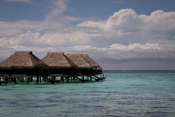 Luxury Overwater Bungalows in Tropical Lagoon with Cloudy Sky