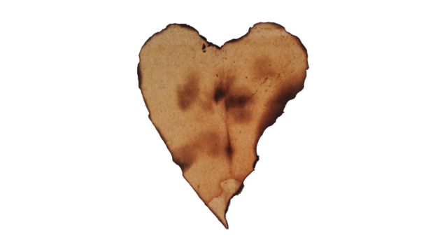Old burnt paper heart, isolated, symbolizing lost love or damage