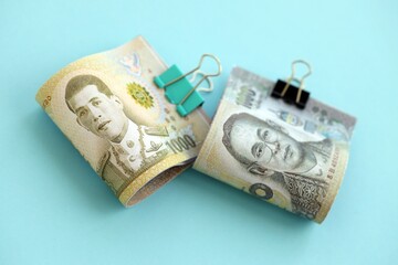 Thai baht money bills in big amount on blue close up. Finance and banking concept