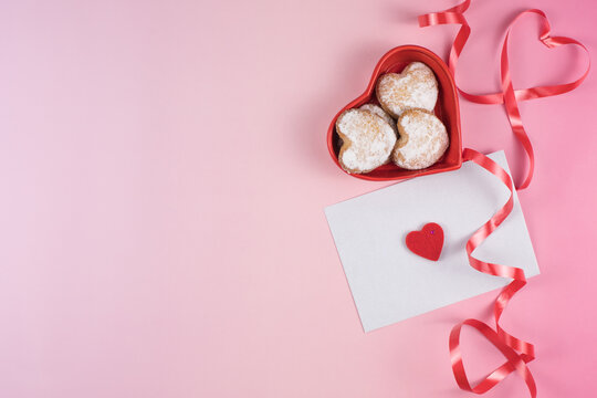 Romantic Valentine setup with heart-shaped cookies and envelope with copy space