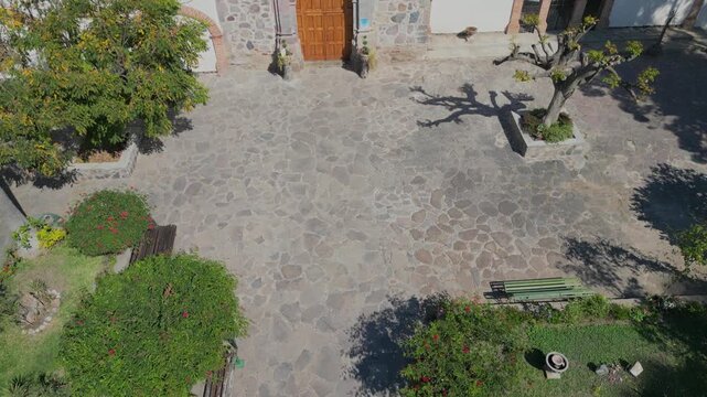 Aerial drone pan uncovering chapel Nuestra Senora del Rosario in Ajijic with mountain and town view