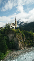 San Geer Scuol church with Inn river in summer, Scuol, Engadin valley, Switzerland