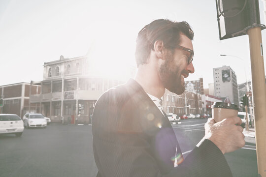 Coffee, happy and businessman in city in morning for commuting to work with creative career. Flare, professional and magazine editor walking with takeaway warm beverage outdoor in town for travel. - Powered by Adobe