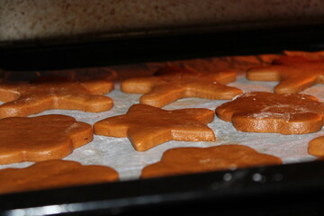 Gingerbread cookies prepared on a baking tray in a kitchen during the holiday season