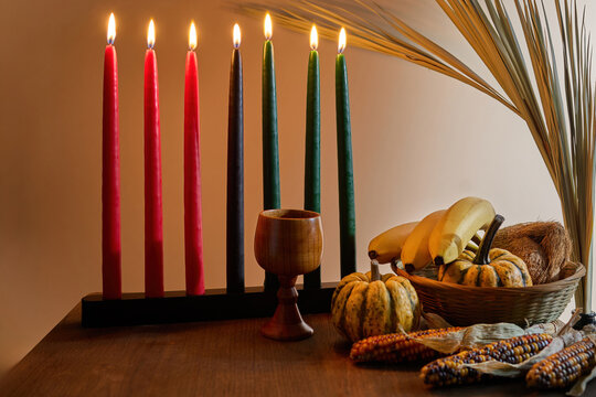 Fototapeta Kwanzaa Table Setting. A festive Kwanzaa display with Kinara, fruits, and vegetables