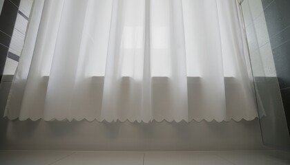 White translucent shower curtain with folds and a scalloped hem hangs in a modern bathroom, backlit by soft, diffused window light creating a serene and minimalist scene