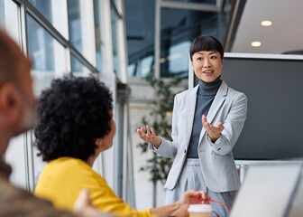 Group of young business people having a meeting or presentation and seminar with digital display whiteboard in the office. Portrait of a young businesswoman leader