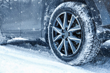 Car on snowy country road, closeup. Adverse weather conditions © New Africa