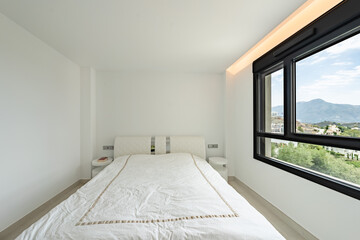 an image of a double bed in a bedroom with mountain views of Marbella 