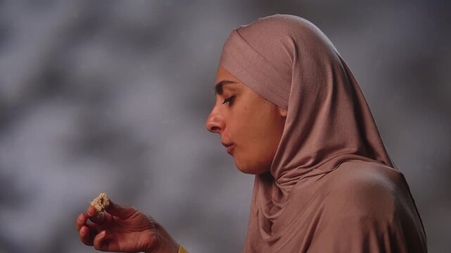 Muslim Woman in Hijab Enjoying a Festive Meal Indoors