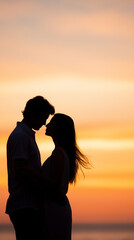 Fototapeta premium Romantic couple standing close together in silhouette at sunset. 