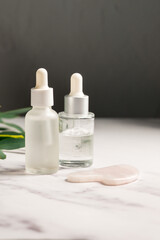 Rose quartz gua sha and oil bottles, abstract beauty photo