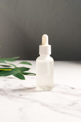 Serum, oil or collagen and peptides in transparent glass bottle. Skincare product