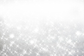 A collection of luxurious, deep emerald green glitter Christmas ornaments hanging against a background of sparkling gold glitter and warm bokeh lights. Holiday background, advertising visual.