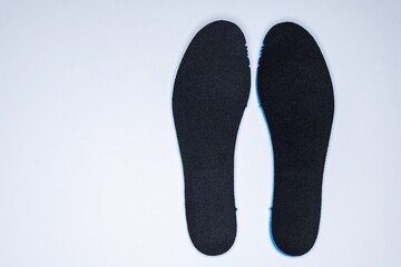 Shoe inserts on a white background. Comfortable orthopedic shoe accessories. Photo taken with flash.