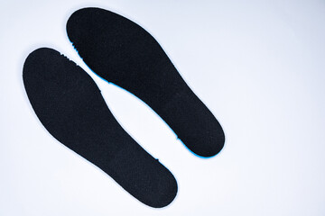 Shoe inserts on a white background. Comfortable orthopedic shoe accessories. Photo taken with flash.