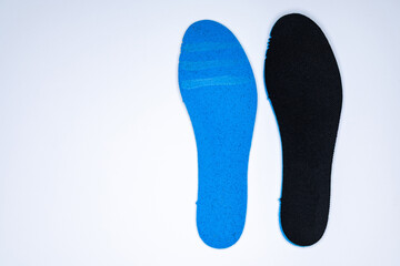 Shoe inserts on a white background. Comfortable orthopedic shoe accessories. Photo taken with flash.