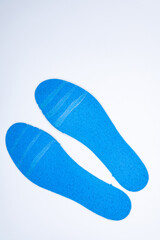 Shoe inserts on a white background. Comfortable orthopedic shoe accessories. Photo taken with flash.