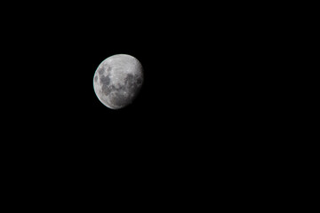 Bright full moon illuminating the dark night sky with visible lunar craters in space