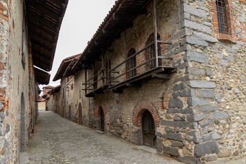 A narrow "rua" (cobblestone street) inside the Ricetto di Candelo, a fortified medieval village in Piedmont. 