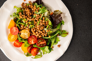 Lentil salad vegetables, tomato, green leaf lettuce tasty snack fresh delicious gourmet food table setting rustic top view copy space keto and paleo diet vegetarian and vegan food