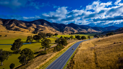 Road landscape mountains valley trees grass sky clouds blue green nature scenic winding highway travel outdoors countryside