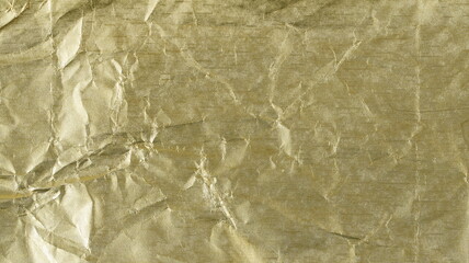 Golden aluminum crumpled foil background and texture