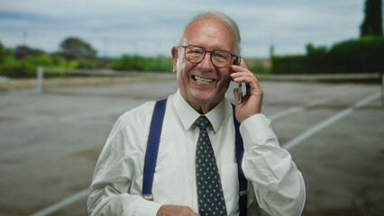 Senior man in business suit using smartphone on outdoor tennis court, displaying various emotions as he communicates during a call.