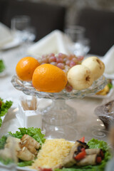Wedding banquet table decorated with fruits and vegetables.