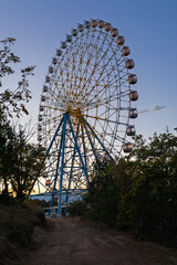 Scenic View Of Giant Ferris Wheel In Mtatsminda Park At Sunset