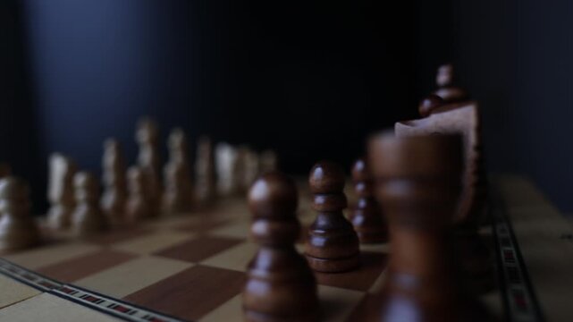 Animated sequence showing chess pieces on revolving board, capturing the essence of strategic decision-making and the black versus white dichotomy in chess