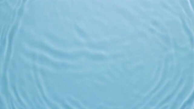 Intersecting water waves forming spontaneous ripples on a pale blue background, creating a clean beauty backdrop suitable for skincare or cosmetic visuals.