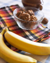 bananas and baked goods in a vase on the table