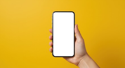Hand holding smartphone with blank white screen against yellow