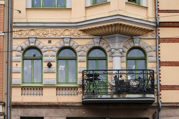 Historic ornate residential building facade with balcony and decorative stonework.
