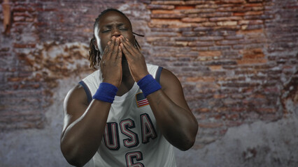 Man clapping hands in studio wearing usa basketball jersey and blue wristbands; pride team spirit unity.