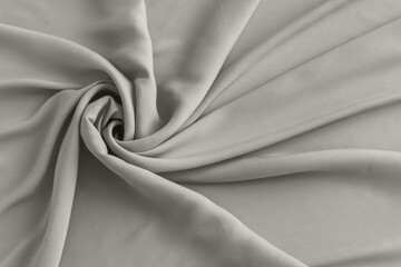 Soft gray fabric swirls in smooth drape and folds with calm, minimalist texture Demonstration Color of the Year 2026