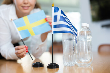 Unrecognizable unfocused woman preparing room for international negotiations and communication...