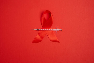 Red ribbon and syringe symbol. Global health awareness.