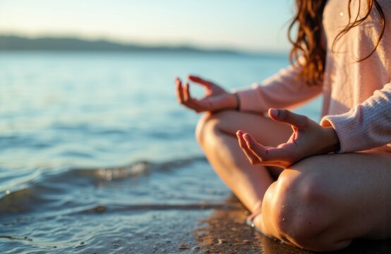 Woman meditating by the water on a quiet beach during sunset meditation - Powered by Adobe