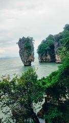 Thailand - picturesque limestone cliffs in the emerald sea and lush tropical greenery