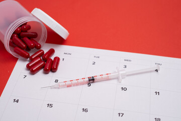 Monthly medication schedule: pills, syringe, and calendar planning