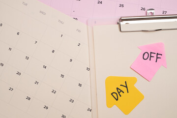 Day off reminder on clipboard and calendar. Scheduling a break.