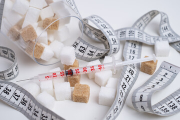 Diabetes and weight management. Sugar, syringe, and measuring tape
