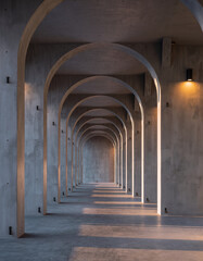 Obraz premium Modern Concrete Corridor with Repeating Arches and Warm Light