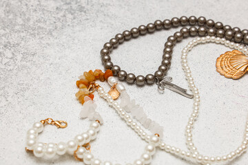 Various types of jewelry displayed on a simple surface with different colors and designs