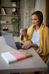 Woman working remotely from home with laptop
