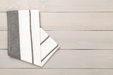 Kitchen napkin on wooden background, top view