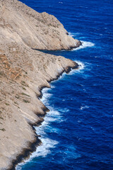 Folegandros coast, contrasting cliff and deep blue sea