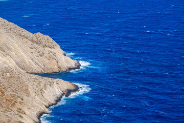 Folegandros coast, contrasting cliff and deep blue sea